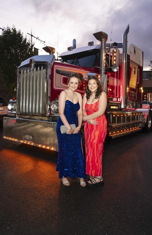 Toowoomba Flexi School graduate Rhianna Hazard (left) and partner Annalease Sayers arrive to the formal in a prime mover at Burke and Wills Hotel, Thursday, October 10, 2024. Picture: Kevin Farmer