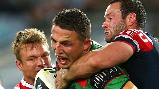 SYDNEY, AUSTRALIA - SEPTEMBER 26: Sam Burgess of the Rabbitohs is tackled by Sam Moa, Jake Friend and Boyd Cordner during the First Preliminary Final match between the South Sydney Rabbitohs and the Sydney Roosters at ANZ Stadium on September 26, 2014 in Sydney, Australia. (Photo by Renee McKay/Getty Images)
