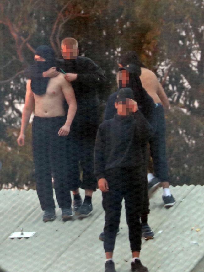 Inmates from the Frank Baxter Juvenile corrections centre Kariong taunt police from the roofs of various buildings. Some are armed with poles tennis rackets ect. Picture: John Grainger