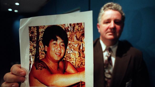 Vic police officer Rod Collins holding picture of kidnapping and murder victim Tuan Anh Le./Murder/Victoria