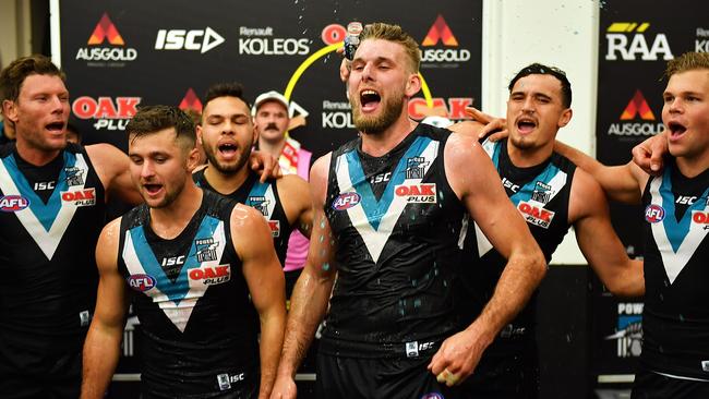 Jackson Trengove belts out the Power song with his former teammates after a win last year. Picture: Daniel Kalisz/Getty Images