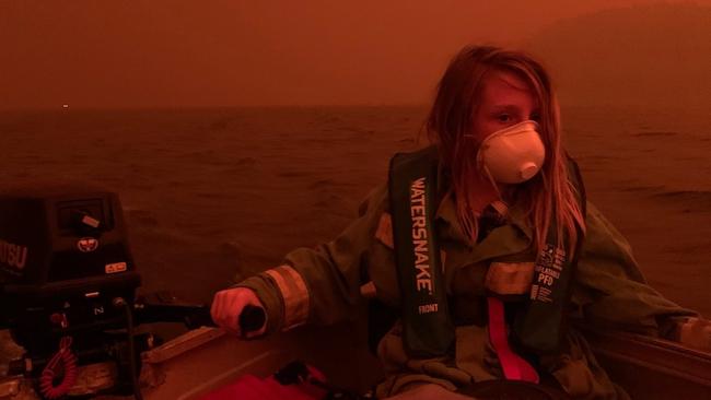 Finn Burns, in a photo taken by his mother as the family sit in their boat on the Mallacoota Lake. Picture: ABC Gippsland