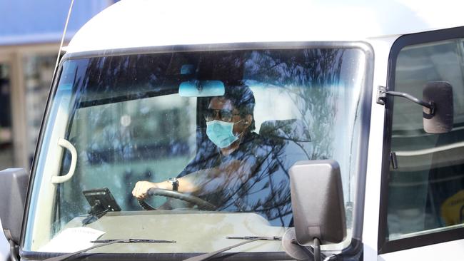 Coronavirus disease – people with masks in cars on the Gold Coast, where three Chinese tourists have tested positive.