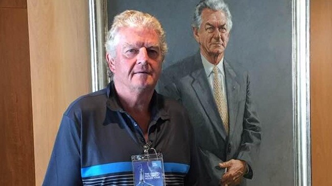 Thomas Eastwood with a portrait of a former Prime Minister Bob Hawke.