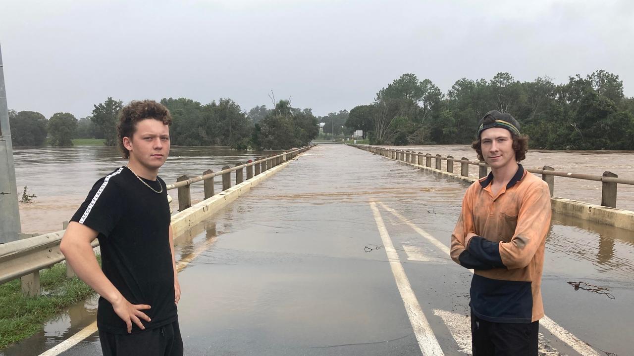 Kodie and Kai Crowther with the flooded Normanby Bridge, looking over to Gympie's Southside.