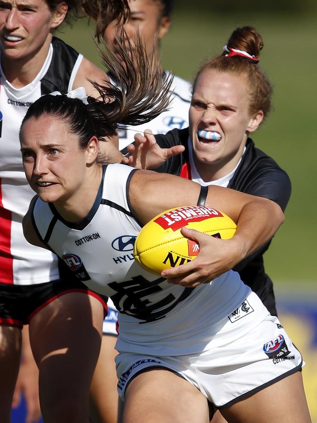 Nicola Stevens of the Blues is tackled by Tilly Lucas-Rodd.