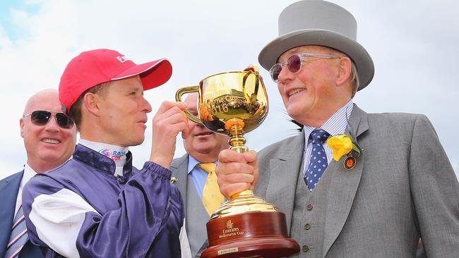 Jockey Kerrin McEvoy celebrates his Melbourne Cup win on Almandin with owner Lloyd Williams. Photo by Michael Dodge/Getty Images.