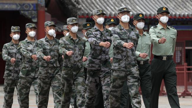 Chinese People’s Liberation Army soldiers march near the Forbidden City in Beijing this week. Picture: AP