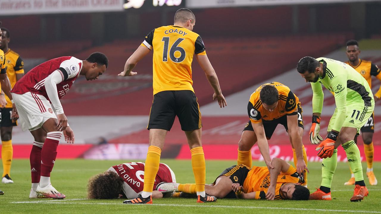 David Luiz of Arsenal and Raul Jimenez of Wolverhampton Wanderers lie injured after a collision. (Photo by John Walton - Pool/Getty Images)