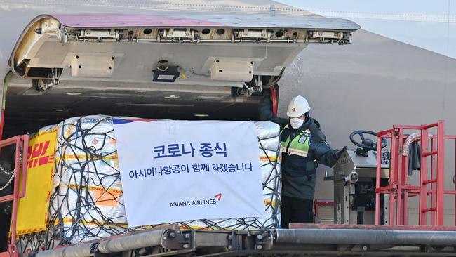 A South Korean worker unloads cargo containing Pfizer's antiviral COVID-19 pill, Paxlovid, at a cargo terminal of the Incheon International Airport. Picture: AFP.