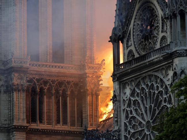 Flames and smoke billow from the roof at Notre-Dame Cathedral in Paris on April 15, 2019. - A fire broke out at the landmark Notre-Dame Cathedral in central Paris, potentially involving renovation works being carried out at the site, the fire service said. (Photo by Thomas SAMSON / AFP)