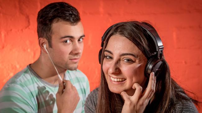 Too much loud music can damage hearing. Nahum Tobgui, 17 and Amy Meka, 18, test out some headphones. Picture: Jake Nowakowski