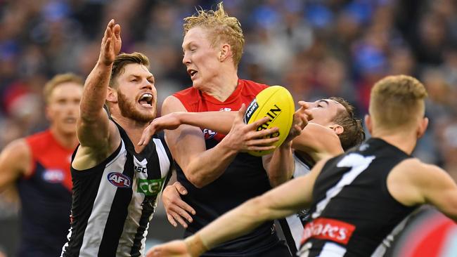 Clayton Oliver looks to dish off a handball under pressure.