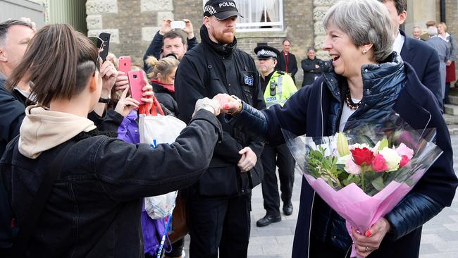 Theresa May fist bumps in Salisbury yesterday after visiting policeman Nick Bailey in hospital. Picture: Getty Images