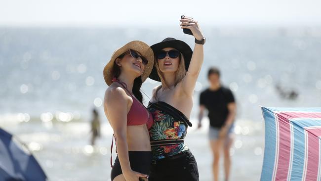 Beachgoers take a selfie at St Kilda beach on Sunday. Picture: NCA NewsWire