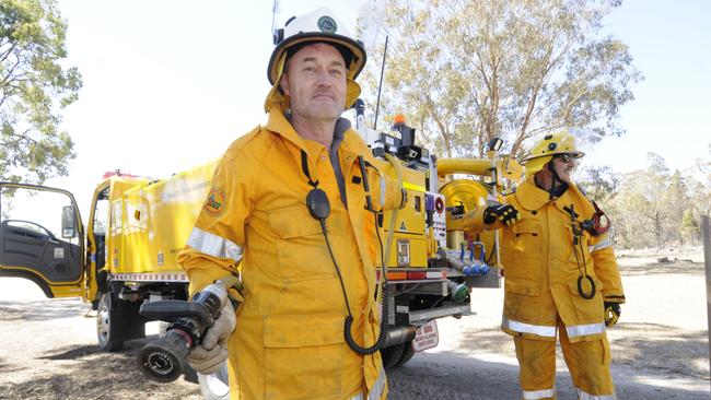 Relief crew from Cabarlah volunteer rural firefighters Byran Brown and Rob Morris mopping up after a fire narrowly missed a dwelling near Stanthorpe. Picture: David Martinelli