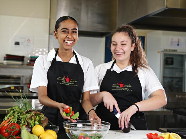 Somika Singh, 14, and Jovana Kostic, 15, cook with school grown produce. Picture: Adam Yip