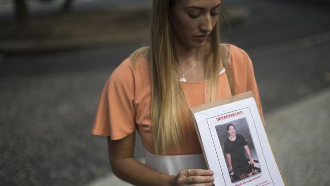 Bonnie Cuthbert, with a photo of her partner Rye Hunt. (AP Photo/Felipe Dana)