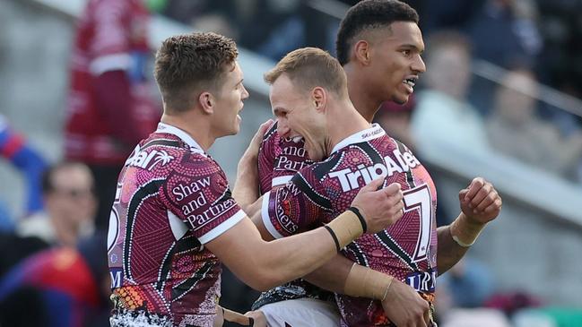 Jason Saab of the Sea Eagles (right) celebrates his try with teammates. Picture: Getty Images