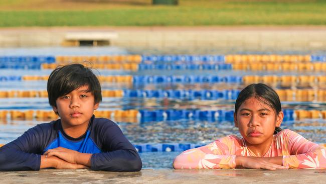 Swimmers Emmanuel and Gabriele Miel will stay sad and disappointed at the government not opening up the Howard Springs camp pool. Picture: Glenn Campbell