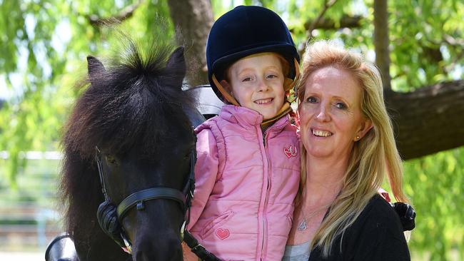 Rochelle Haralambous and her daughter Tia with Little Fella at their home in Park Orchards. Picture: Josie Hayden