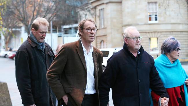 Doctor Stephen Edwards (second from left with white shirt and brown jacket) leaving the Supreme Court in Hobart after being given bail. Doctor Edwards is accused of killing his mother Nelda Mavis Edwards 88 at Sandy Bay. Picture: NIKKI DAVIS-JONES