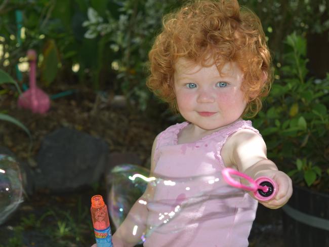 Little Mia Depuit, 2, was happy playing with bubbles when returned to the Whitsundays this week for the first time since she was rushed to hospital in Brisbane 16 months ago with a rare type of cancer.