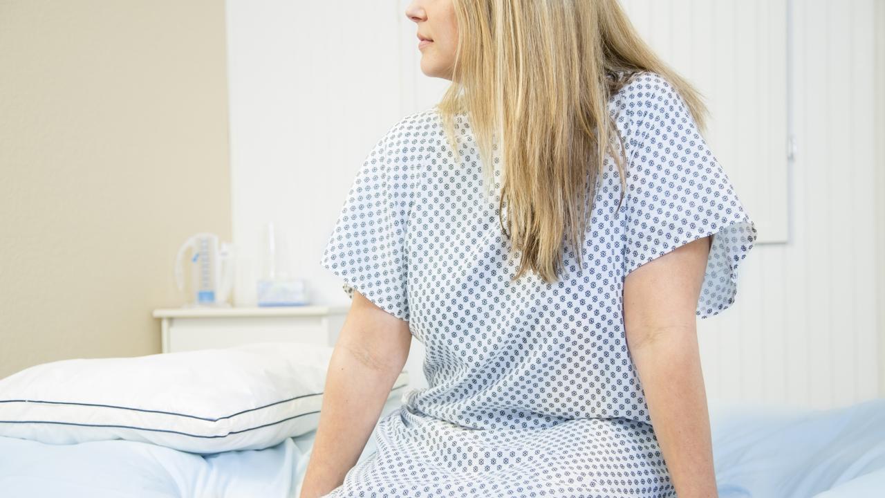 Mid-adult woman in gynaecologist's office for her annual check up. Women's health concept.