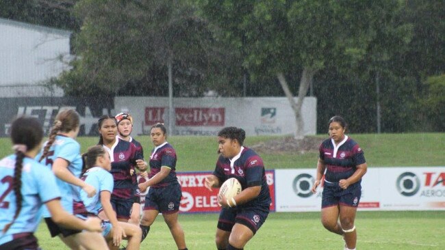 Ipswich State High School players toil hard against Keebra Park in the rainy conditions during their Titans Cup clash at the North Ipswich Reserve.