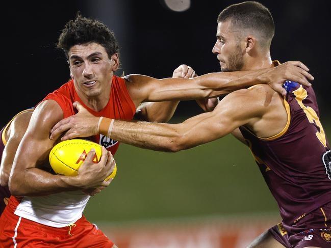 Sydney's Justin McInerney fends off Brisbane's Josh Dunkley during the AFL pre season match between the Sydney Swans and Brisbane Lions at Blacktown International Sports Park, Sydney on February 29, 2024. Photo by Phil Hillyard(Image Supplied for Editorial Use only - Phil Hillyard  **NO ON SALES** - Â©Phil Hillyard )