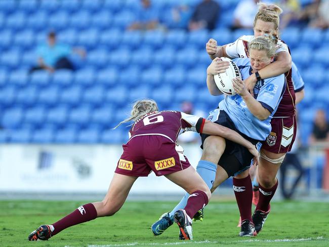 Rebecca Young is crunched by the Queensland defence while playing for NSW last year. Picture: Peter Wallis