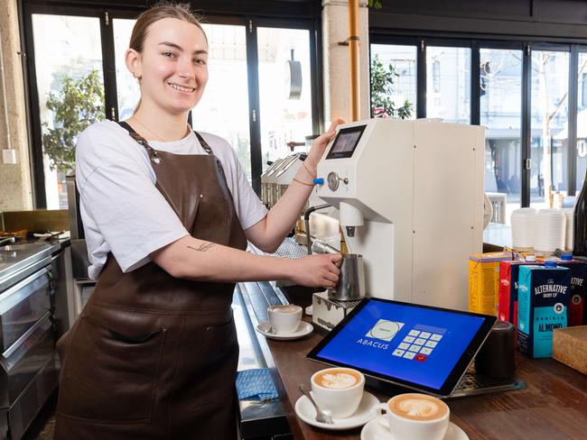 Maya Shepherd, 19, with robot milk steamer at Abacus in South Yarra. Hundreds of Melbourne cafes are replacing baristas with futuristic automated milk steamers and are said to save cafes Ãthousands a weekÃ . Picture: Jason Edwards