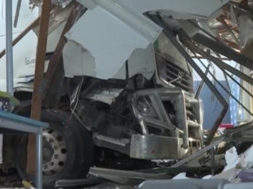 Multiple vehicles and a school building were damaged when a truck drove through an intersection at Moorebank, Sydney, on June 29, 2024. Picture: 7News