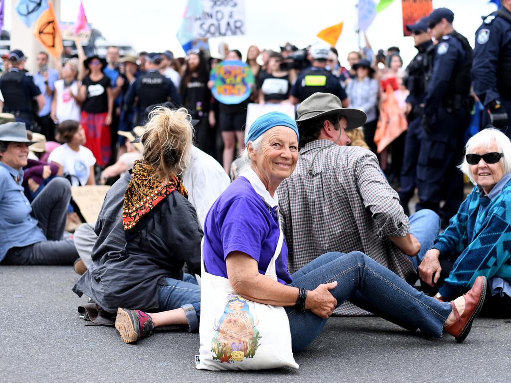 Activists glued their hands to a bridge in Brisbane. Picture: AAP Image/Dave Hunt