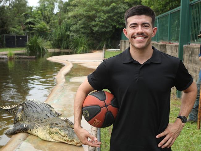 Freddy Webb shows off his basketball skills with monster croc, Speckles, at Crocodylus Park. Picture: Sam Lowe