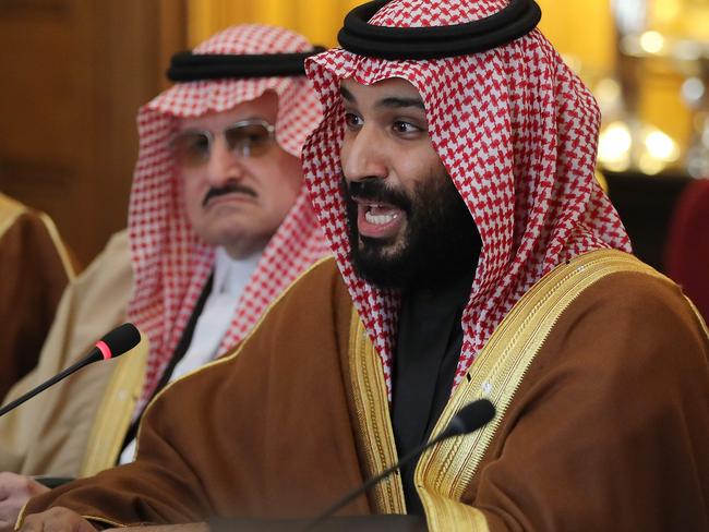 Saudi Arabia's Crown Prince Mohammed bin Salman (R) gestures during a meeting with Britain's Prime Minister Theresa May (unseen) and other members of the British government and Saudi ministers and delegates at number 10 Downing Street, in central London, on March 7, 2018.  British Prime Minister Theresa May will "raise deep concerns at the humanitarian situation" in war-torn Yemen with Saudi Crown Prince Mohammed bin Salman during his visit to Britain beginning Wednesday, according to her spokesman. / AFP PHOTO / POOL / Dan Kitwood