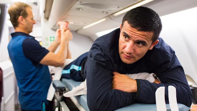 Tim Cahill receives treatment on his ankle.