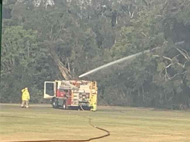 Firefighters tackling a blaze in bush near the Helensvale Aquatic Centre.