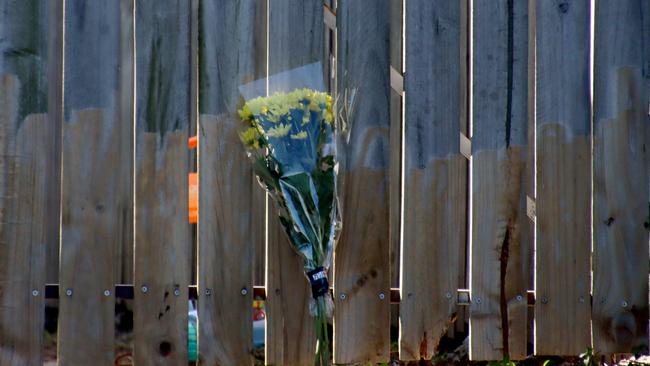 Flowers left near the home where Sunday’s shooting occurred. Picture David Clark