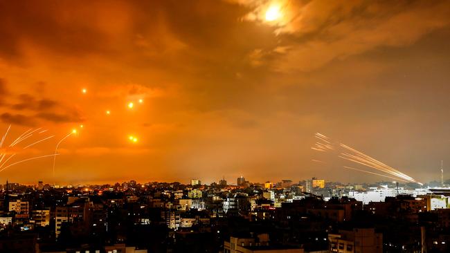 Rockets fired by Palestinian militants from Gaza City are intercepted by the Israeli Iron Dome defence missile system. Picture: Eyad Baba/AFP