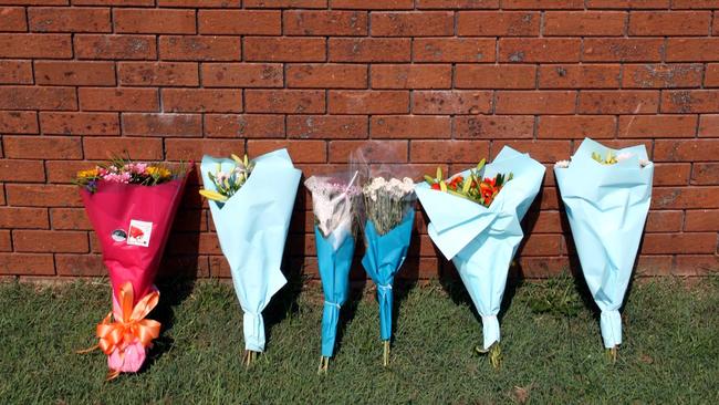 Flowers sit outside the house in Macquarie Grove, Caves Beach, where Stacey McMaugh and partner Robert Pashkuss were murdered on January 6, 2008.