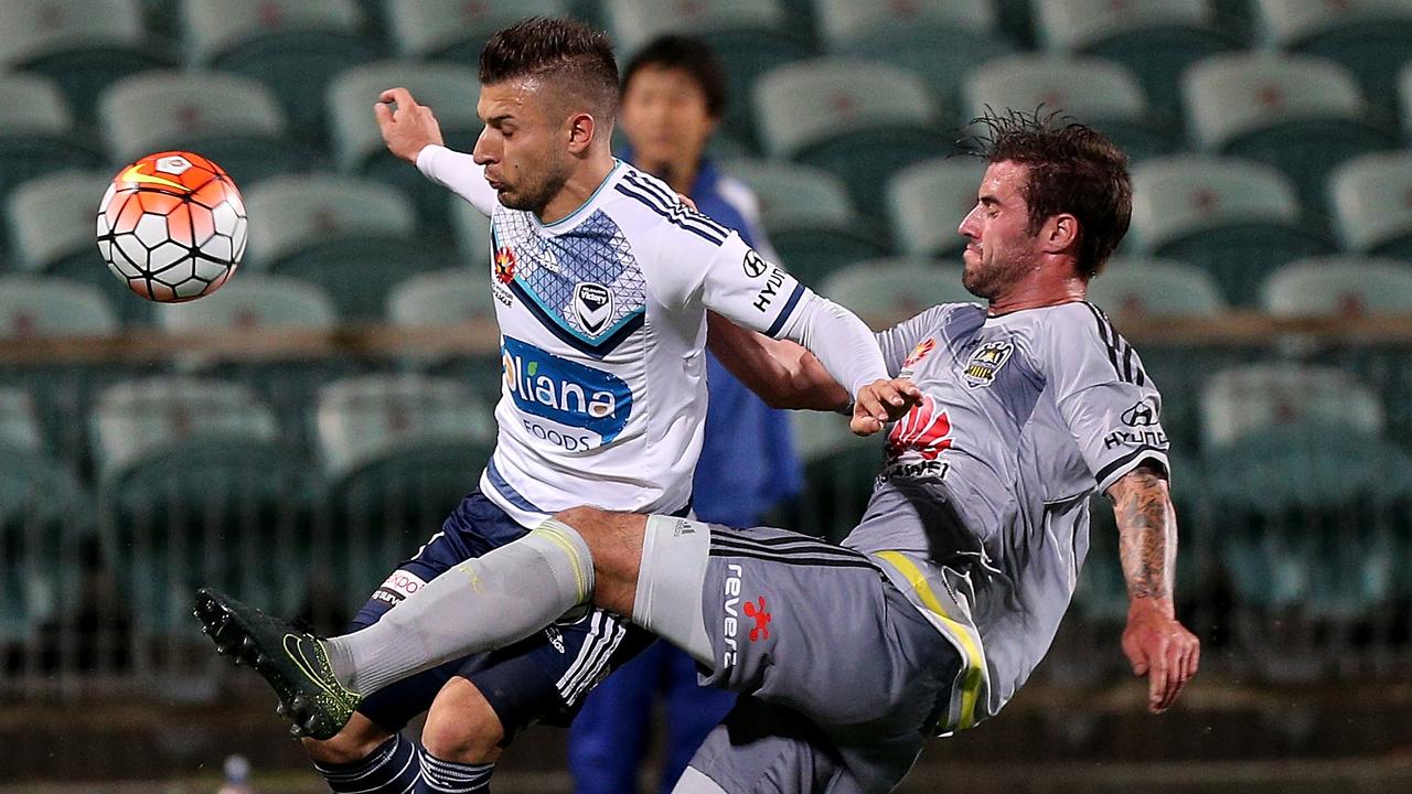 Wellington's Tom Doyle challenges Melbourne's Kosta Barbarouses in the Hyundai A-League football match between Wellington Phoenix and Melbourne Victory, at QBE Stadium, Auckland, New Zealand, Saturday, Dec. 5, 2015. (AAP Image/David Rowland) NO ARCHIVING, EDITORIAL USE ONLY