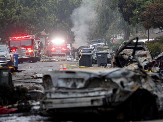 Fifteen cars were destroyed on a residential street after a small plane crashed. Picture: AFP