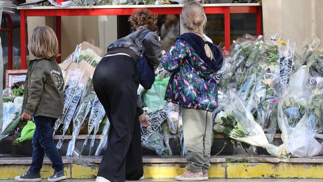 Members of the public adds to a floral memorial at the Gambetta high school in Arras, northeastern France on Saturday. Picture: AFP