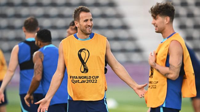 England's forward Harry Kane (L) speaks with England's defender John Stones