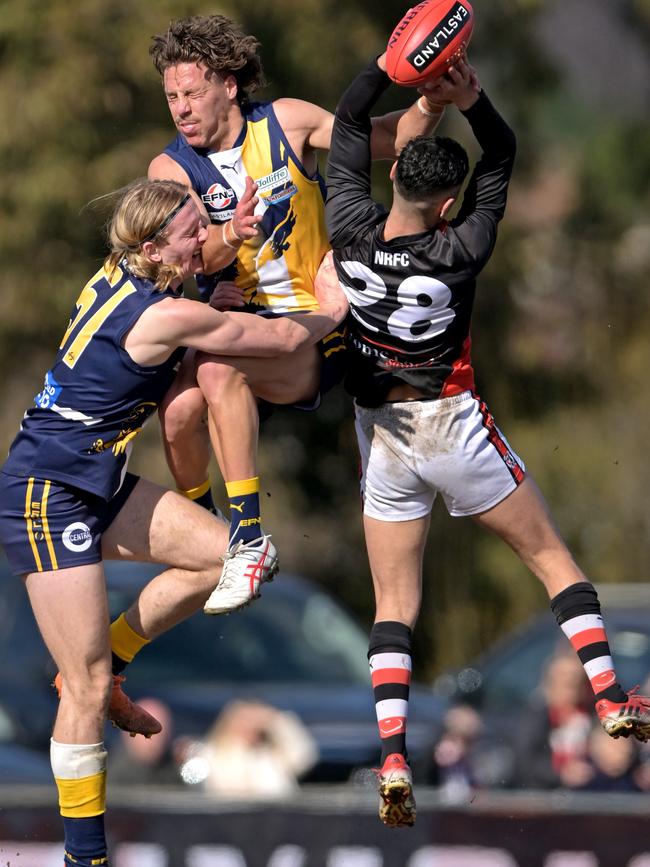 EFNL: Beaconsfield pair Benjamin Schultze and Joshua Mounter tangle with North Ringwood’s Robin Nahas. Picture: Andy Brownbill