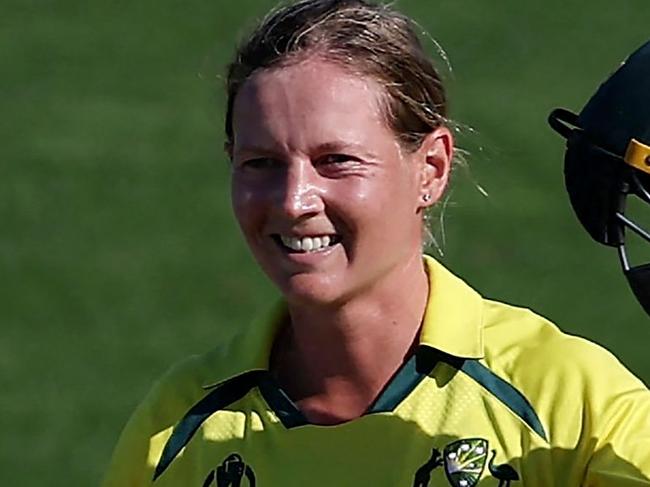 (FILES) In this file photo taken on March 22, 2022 Australia's captain Meg Lanning celebrates after reaching her century (100 runs) during the Women's Cricket World Cup match between Australia and South Africa at the Basin Reserve in Wellington on March 22, 2022. - Waiting tables in her local cafe and hanging out with friends and family helped rekindle Meg Lanning's love of cricket and intensified her drive to steer top-ranked Australia to another Twenty20 World Cup title this month.The decorated women's skipper took a indefinite months-long hiatus in 2022 after an intense few years, sparking fears she would not return. (Photo by Marty MELVILLE / AFP)