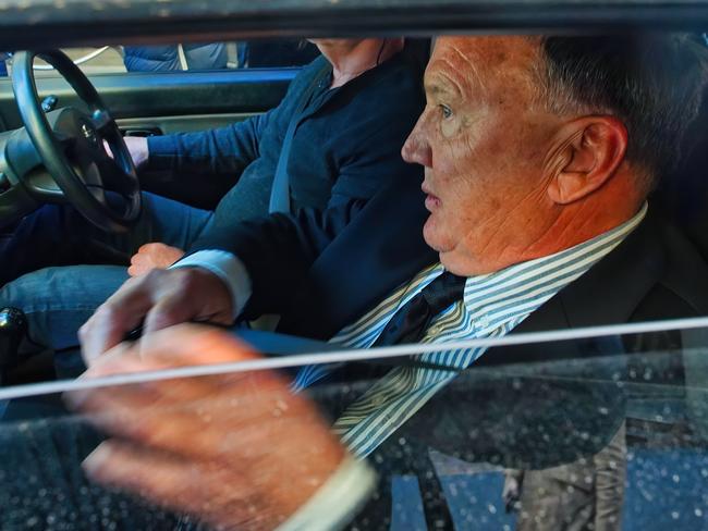 Mr Mathieson escapes the media pack in a ute. Picture: Luis Enrique Ascui