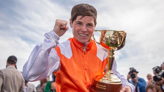 Winning jockey Craig Williams holds the Melbourne Cup yesterday after surviving a tight finish. Picture: Jason Edwards