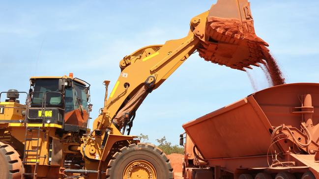 Bauxite ore being tipped into trucks at the Bauxite Hills mine, 100kms north of Weipa in Queensland. Picture: Peter Carruthers